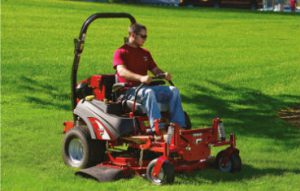 Man Mowing the yard and doing yard work outside