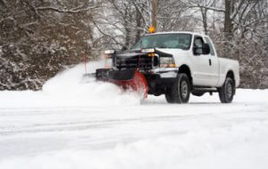 Truck snowplowing the road during the winter
