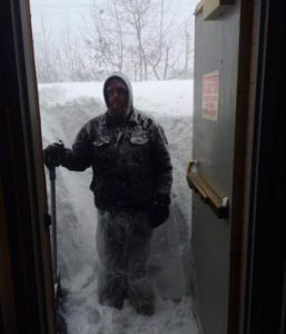 man shoveling his driveway
