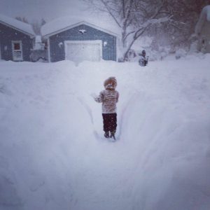 little kid playing in snow
