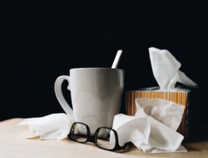 tissues and coffee cup with glasses 