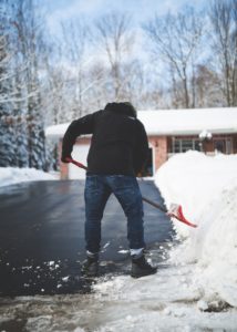 Man shoveling driveway