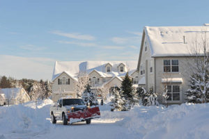 Snow plowing truck in a community